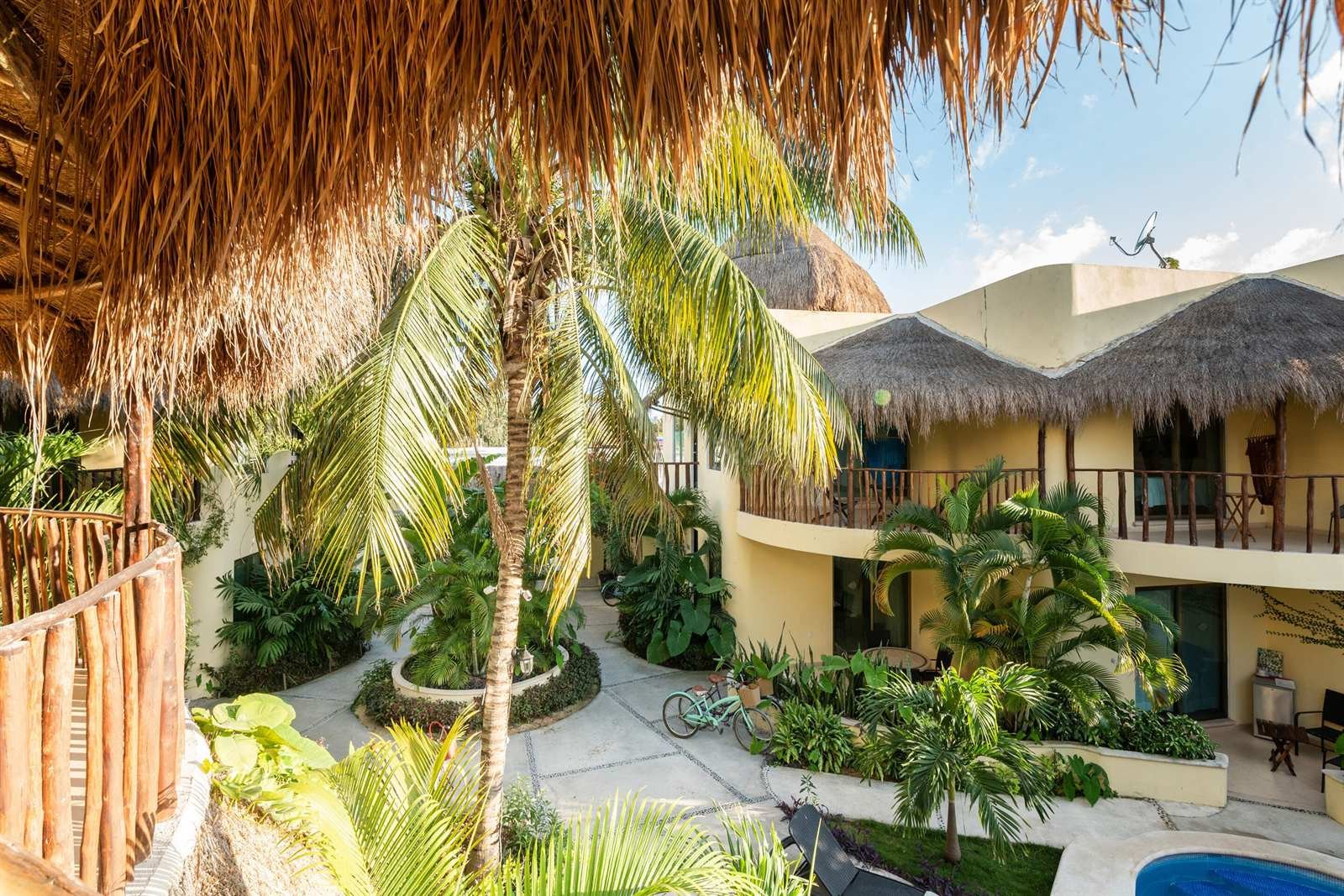 Villas Akalan: tropical courtyard seen from under a palapa roof