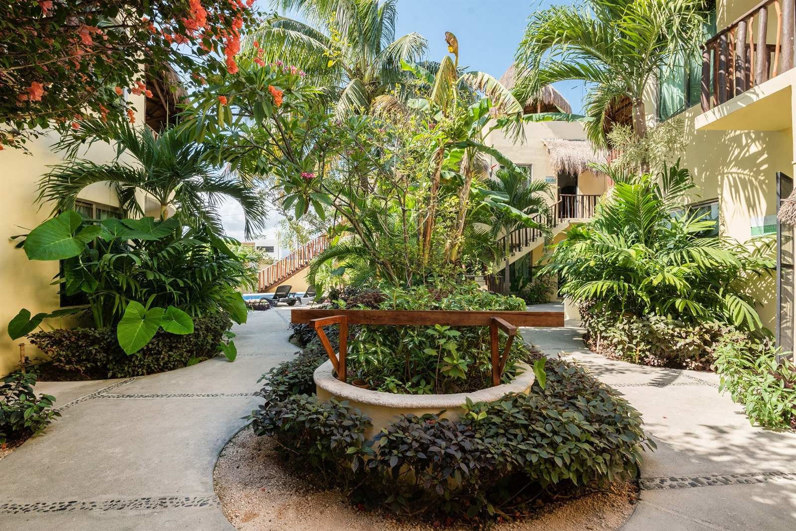 Villas Akalan: garden path with a central planter and tropical plants