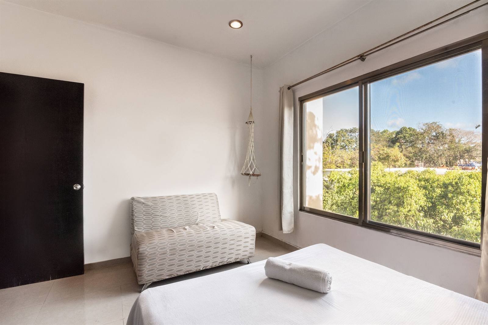 Villas Akalan: apartment bedroom with a large window and a sofa